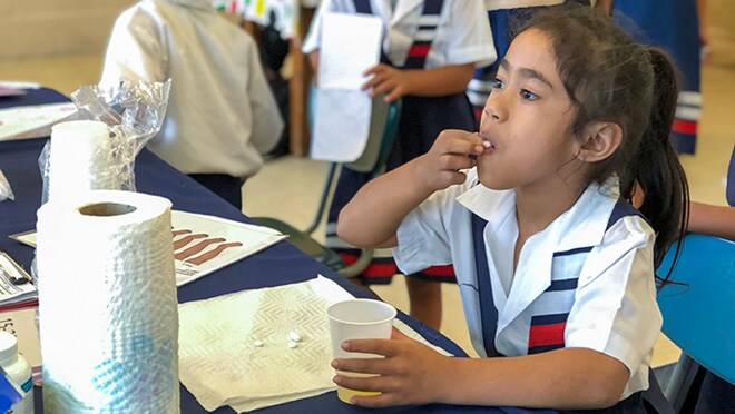 Girl in school uniform taking mediation