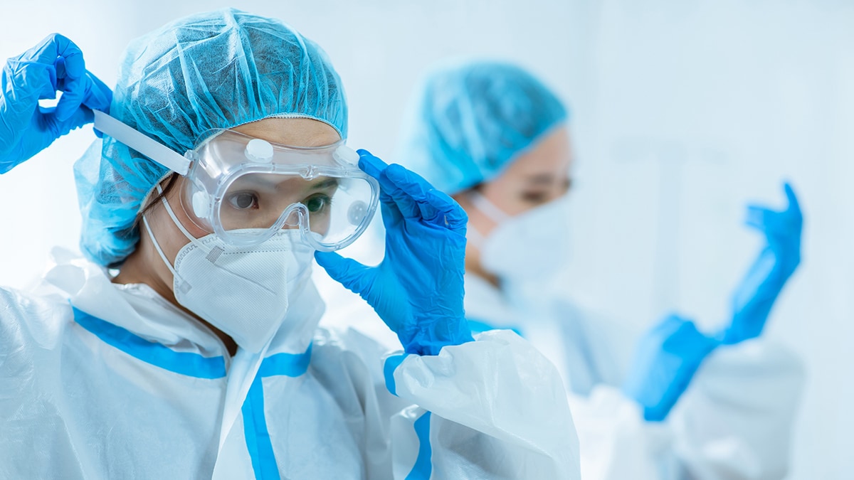 Female medical workers wearing protective clothing.