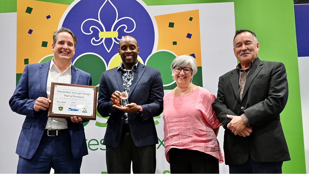 Three men and one woman from the Port of Portland are holding the 2023 PtD Award they received at the National Safety Congress and Expo