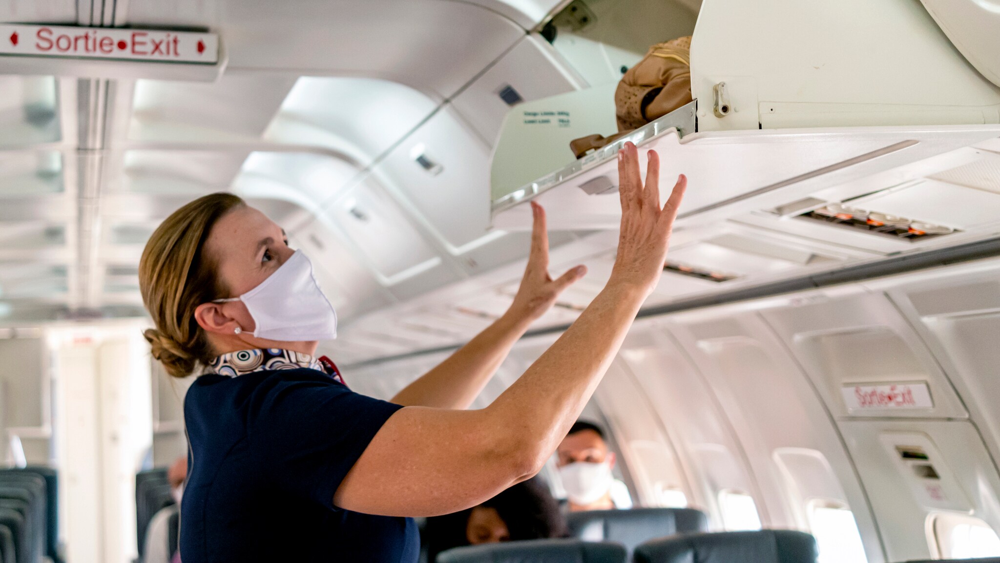 Female aircrew member wearing a mask.