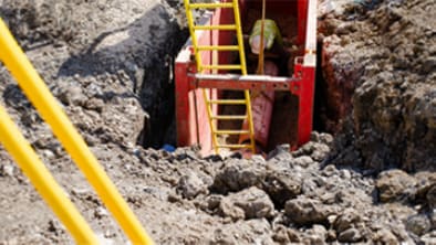 Trench with a yellow ladder.