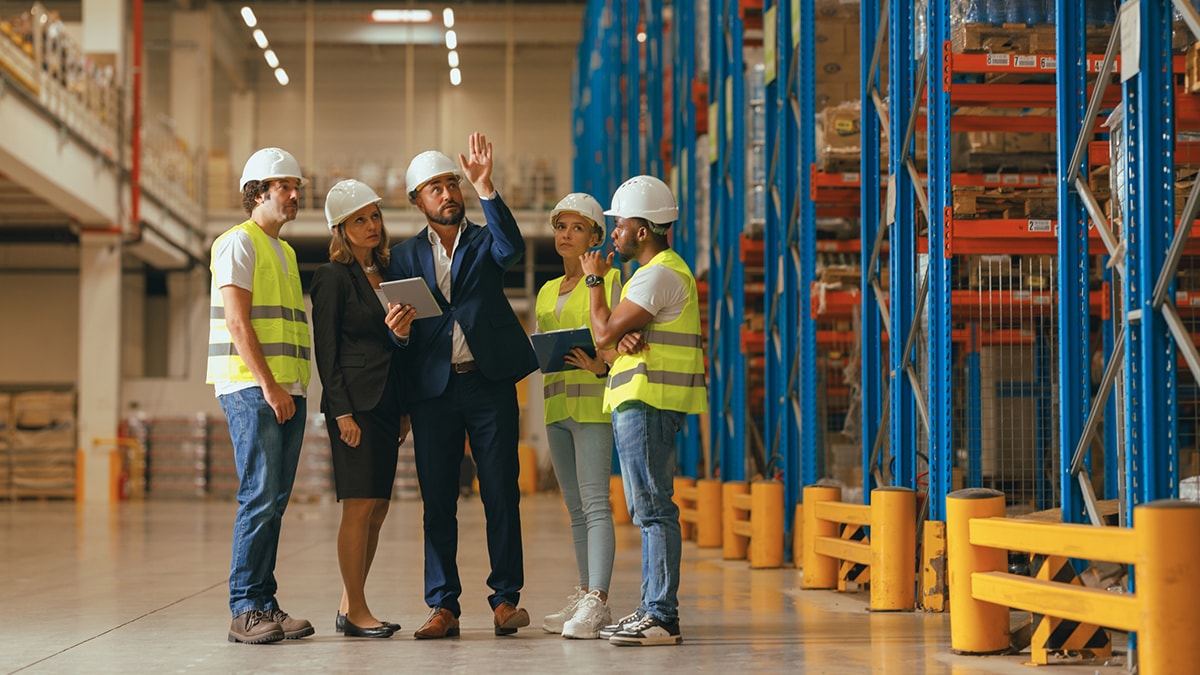 Group of male and female workers on a construction site.