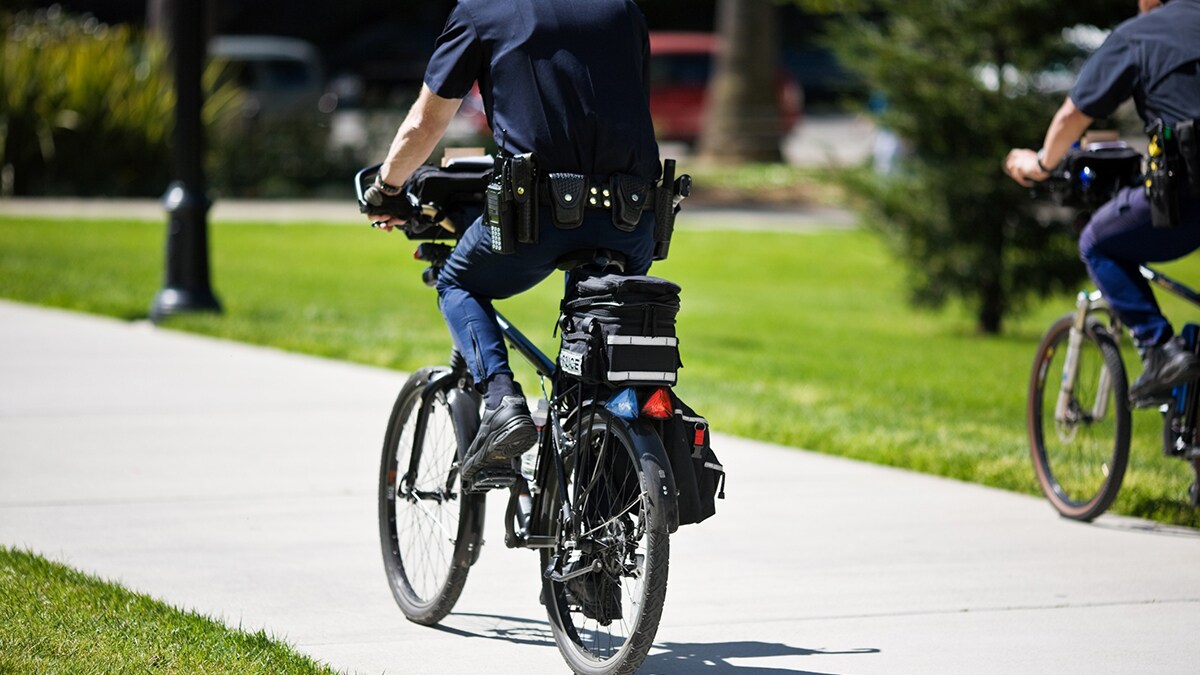 Two police officers riding bicycles.