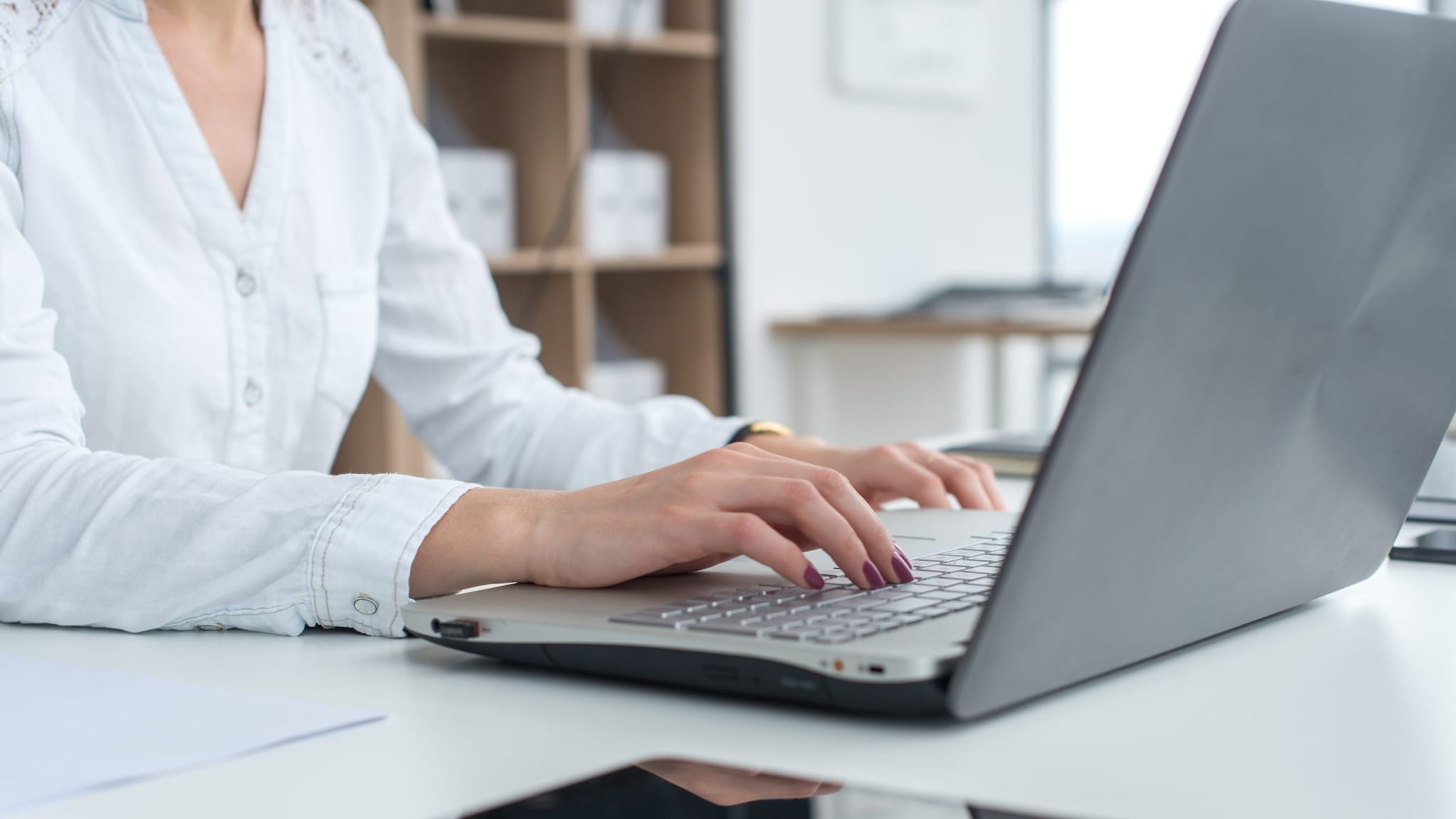 Female researcher assessing data using a computer.