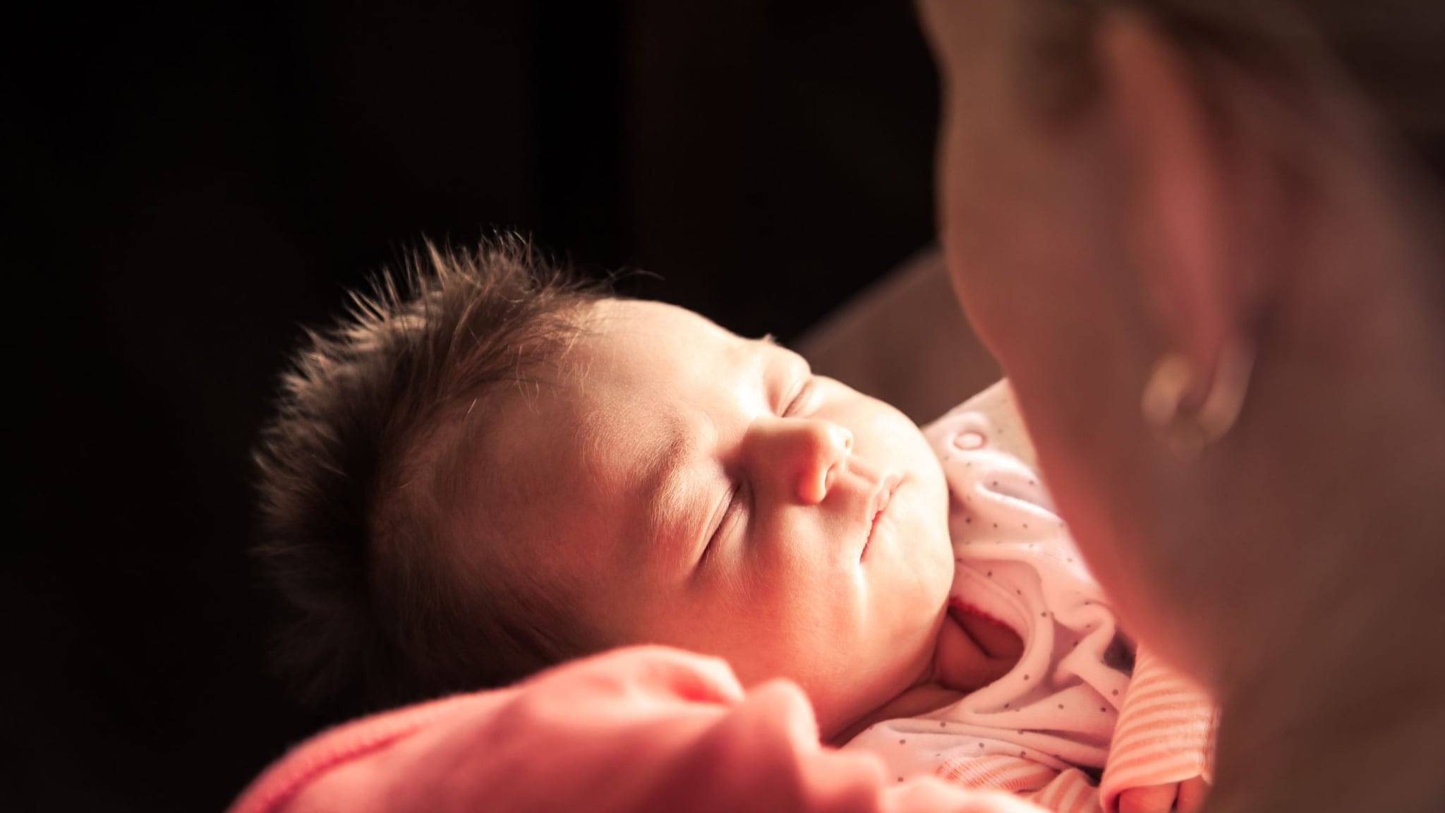 Mother holding newborn.