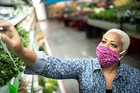 Woman with face mask shopping at supermarket