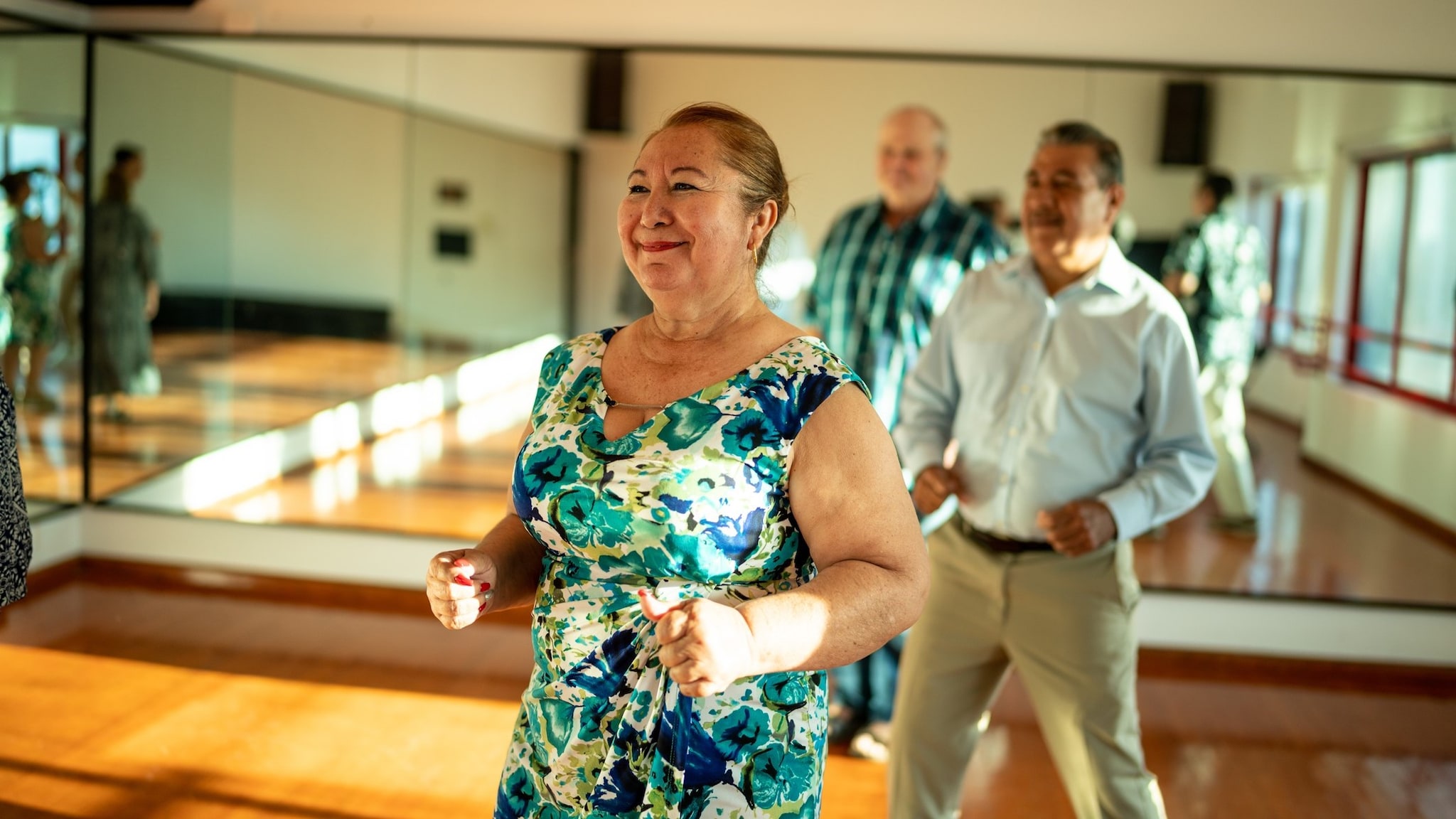 Older adults dancing in a room.