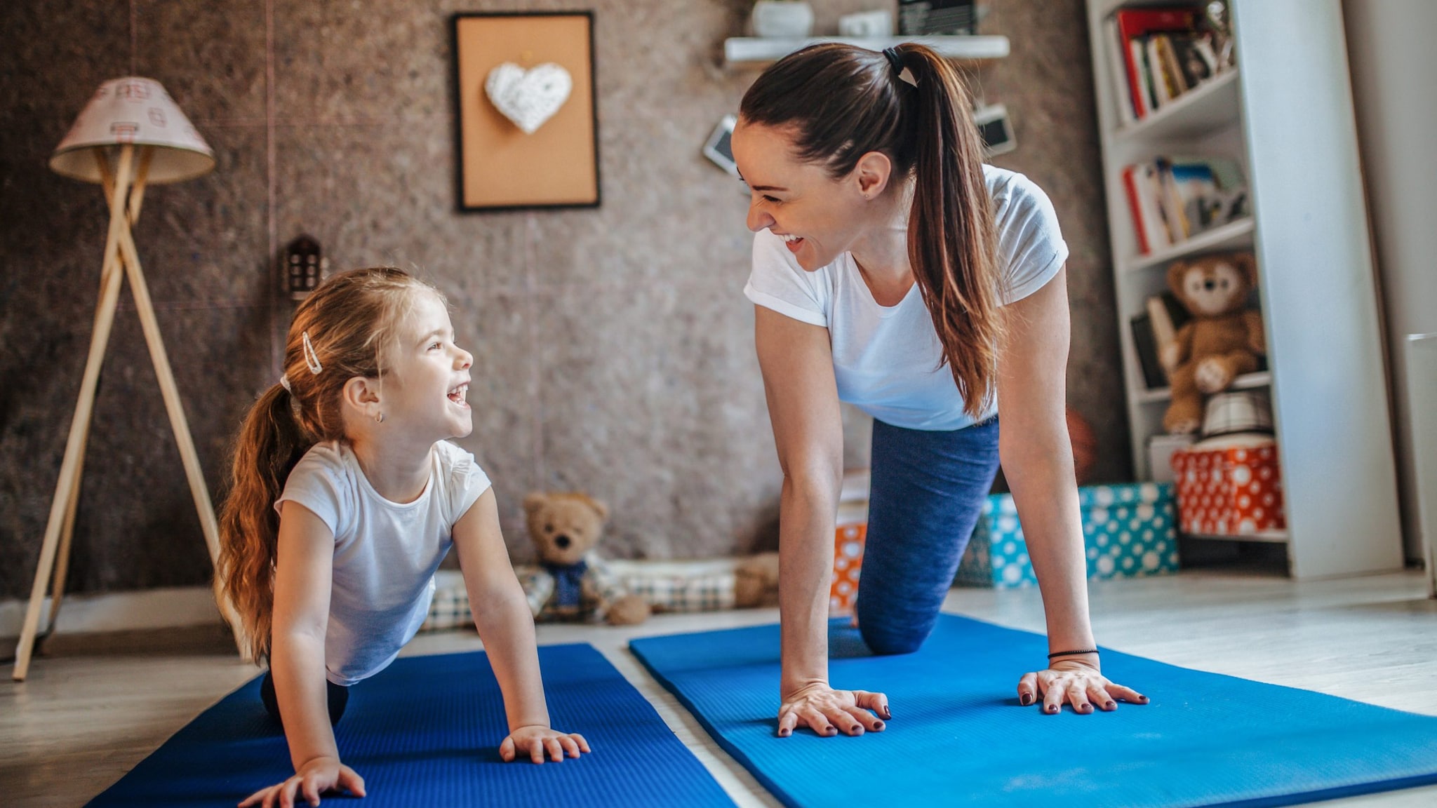 Mother and daughter on mats.