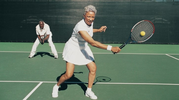 Older couple playing tennis