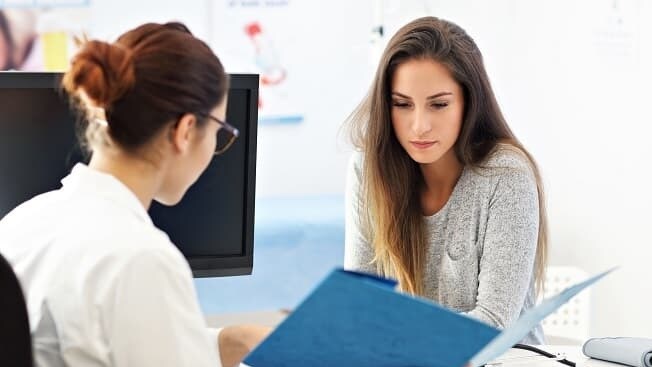 woman talking to health care provider