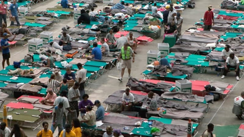 Shelter worker walking through emergency shelter