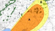 An arial view of a city map with colored shapes indicating areas of radiation exposure due to fallout.