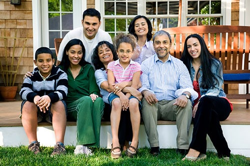 A family sitting outside on a patio smiling