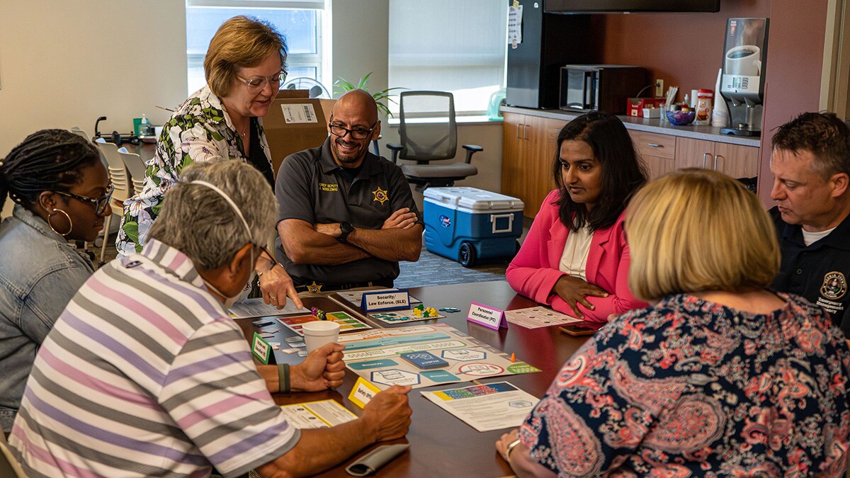 Group of people around table playing TEST