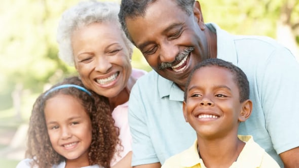 Grandparents enjoying a day outside with their granddaughter and grandson.