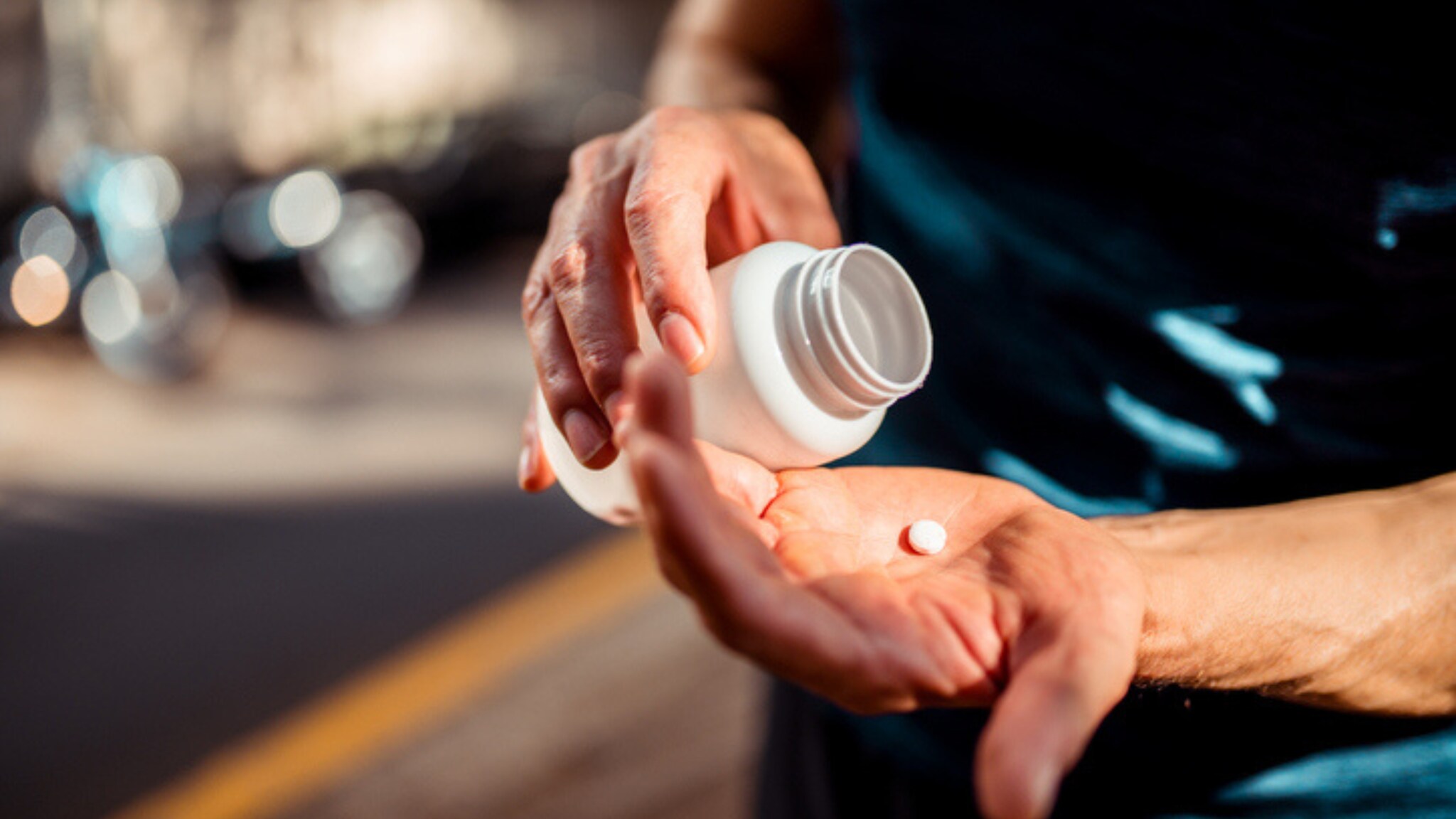 Man with antibiotic in palm of hand