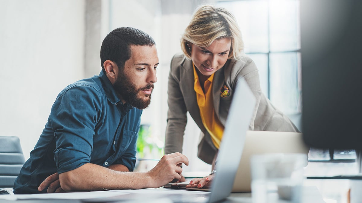 Man and woman looking at laptop screen