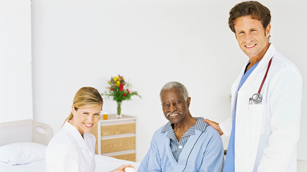 Doctor and nurse with older adult male patient