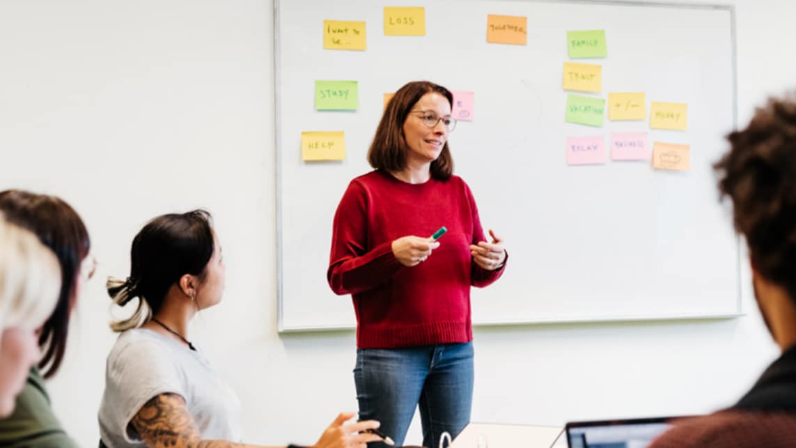 Woman discussing suicide prevention with a group of people