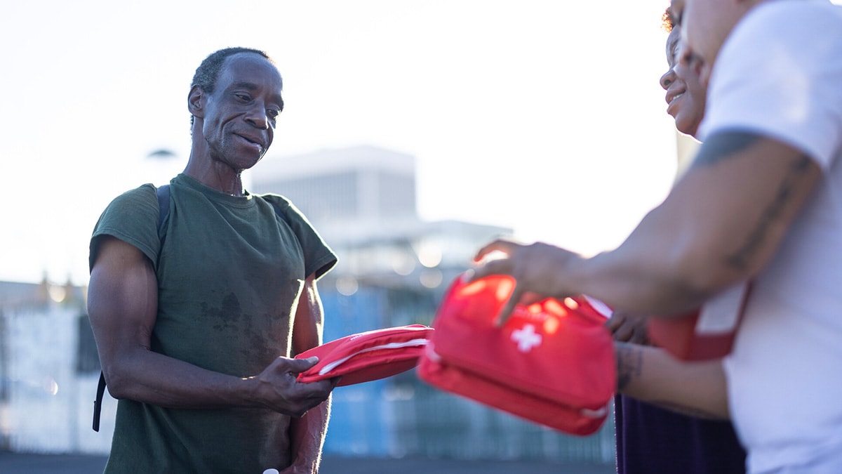 A man receives aid from syringe services program workers.