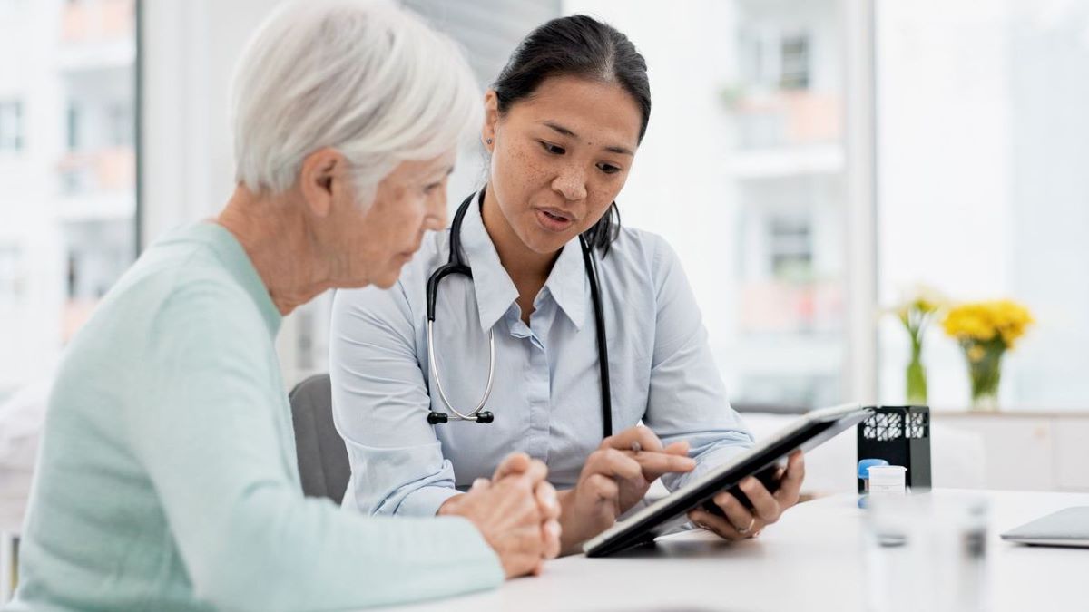 A female doctor and female reviewing results on a tablet.