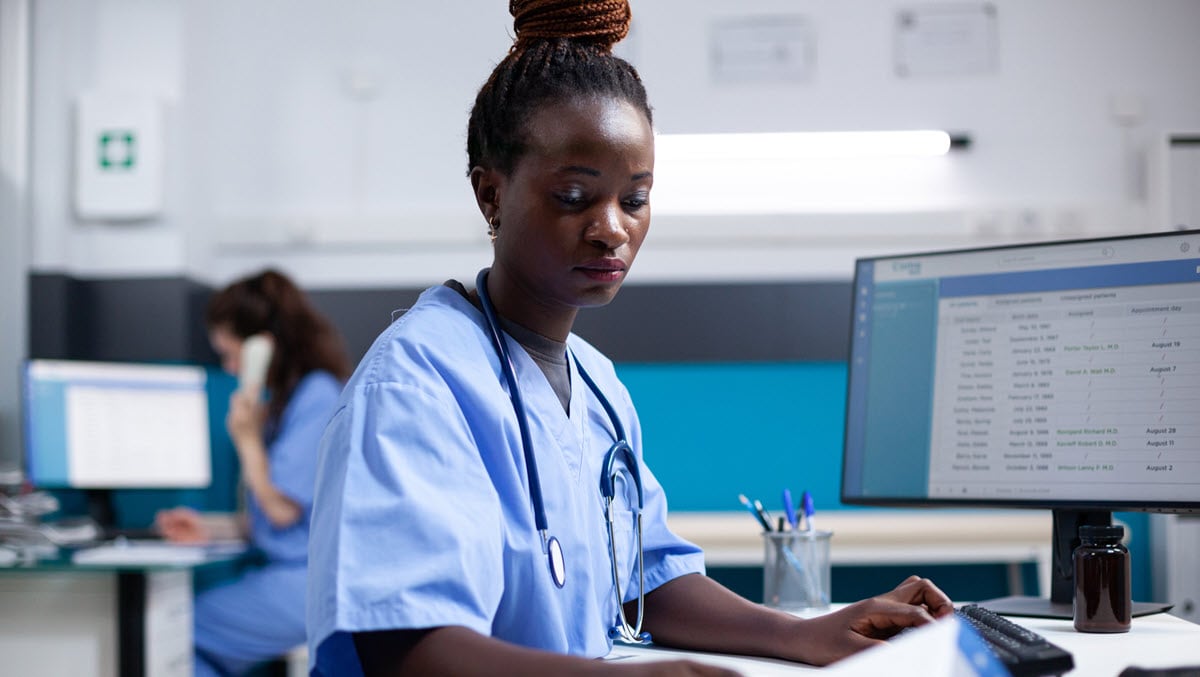 Nurse comparing data in medical office