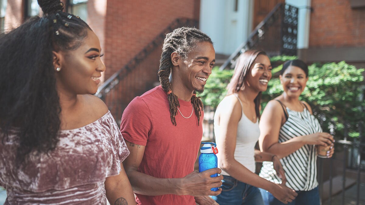 A group of people talking outside.