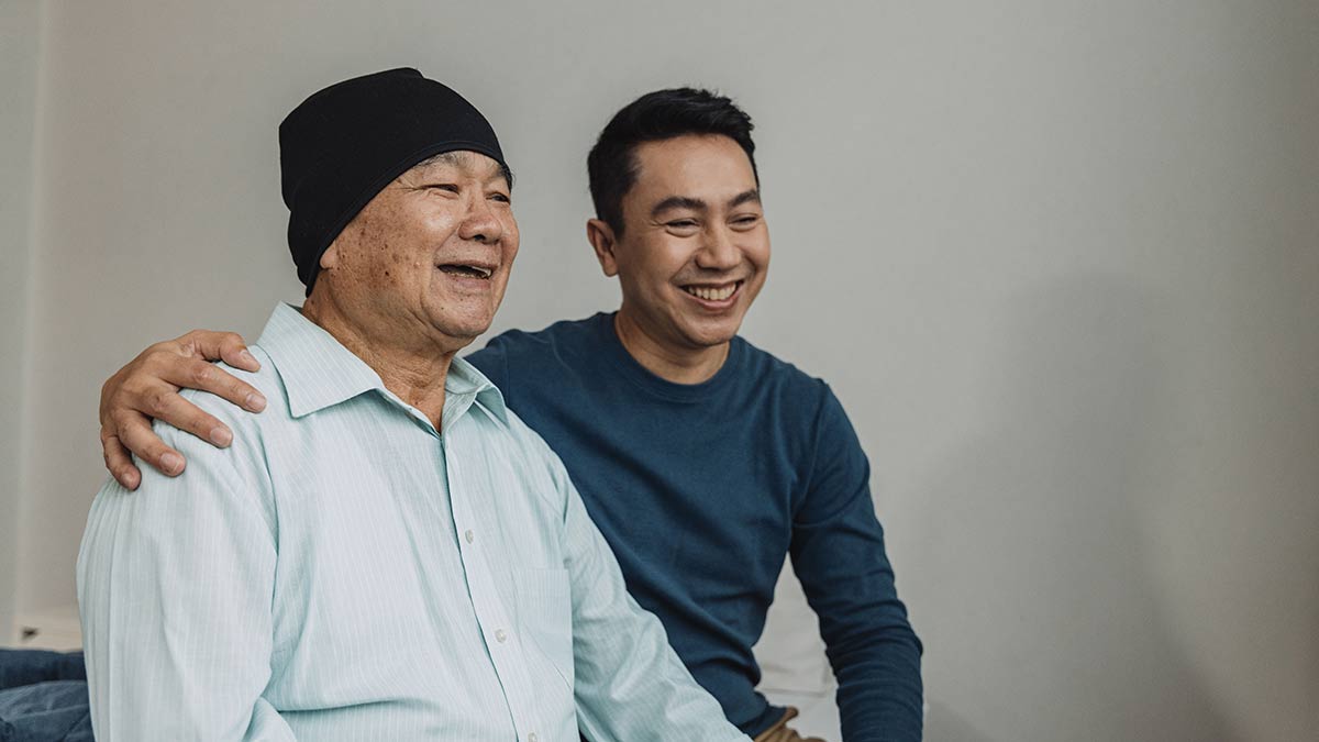 Father, a cancer patient, enjoys talking with his son.