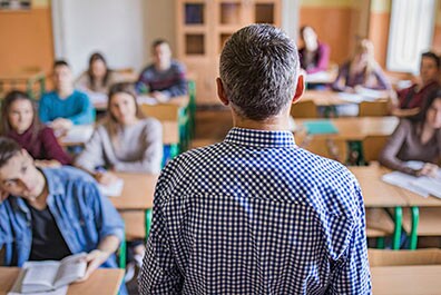 Teacher speaking to high school students.