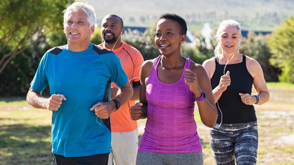 4 people of diverse ethnicities jogging outdoors