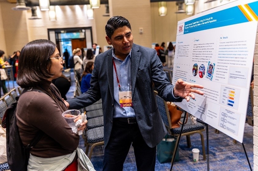 A UnidosUS affiliate presents a poster highlighting vaccine outreach efforts at the 2024 EHFA Vaccine Program Convening.