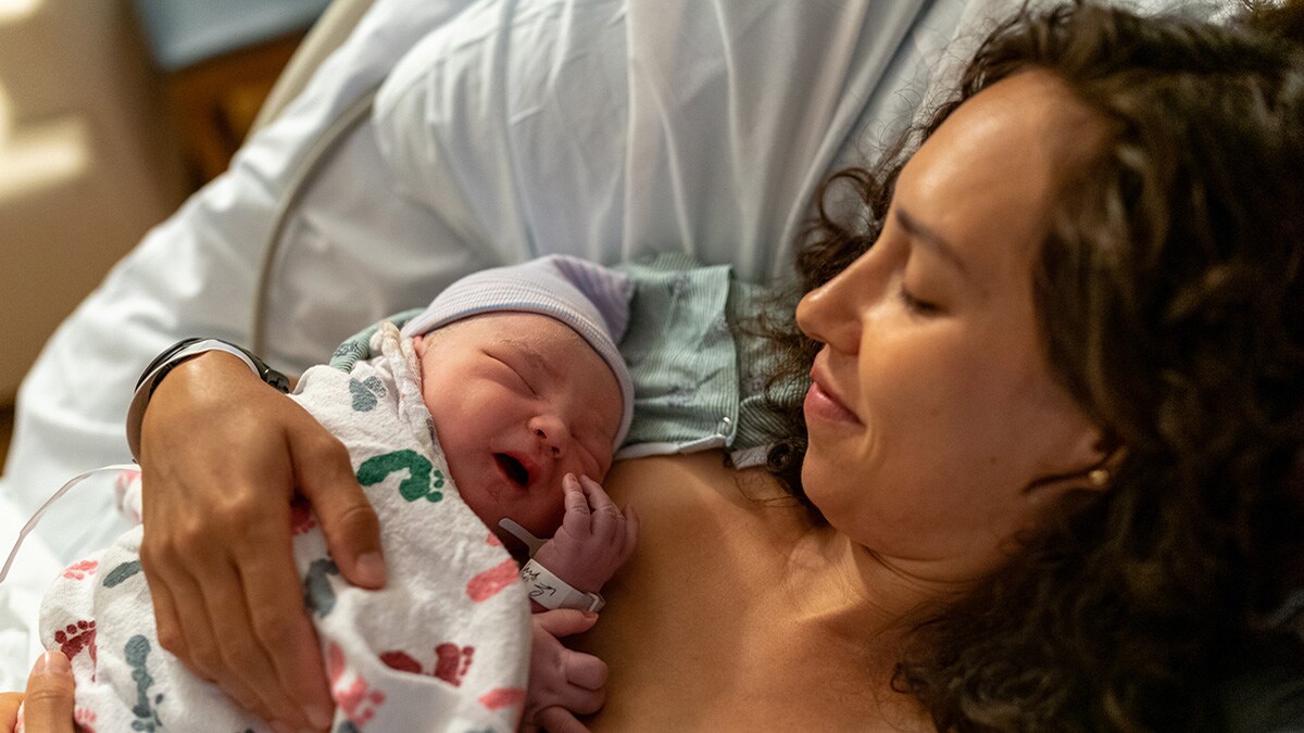 A mother enjoying skin-to-skin bonding with her newborn baby