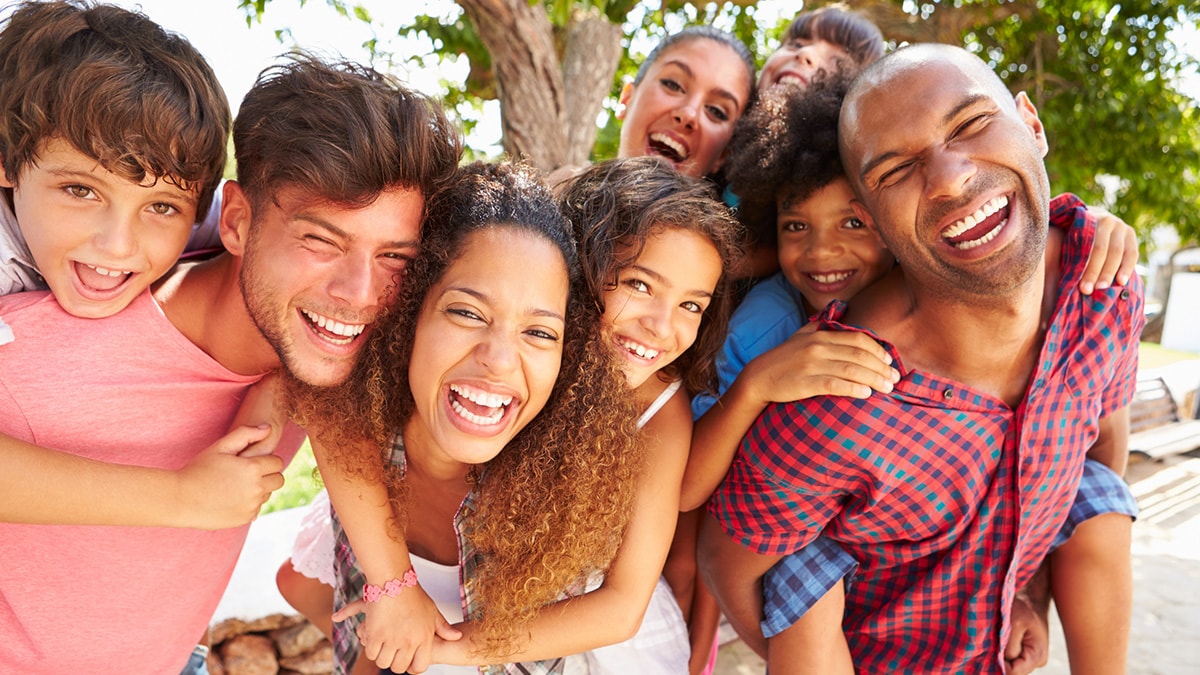 Diverse group of people including adults and children of different races and ethnicities.