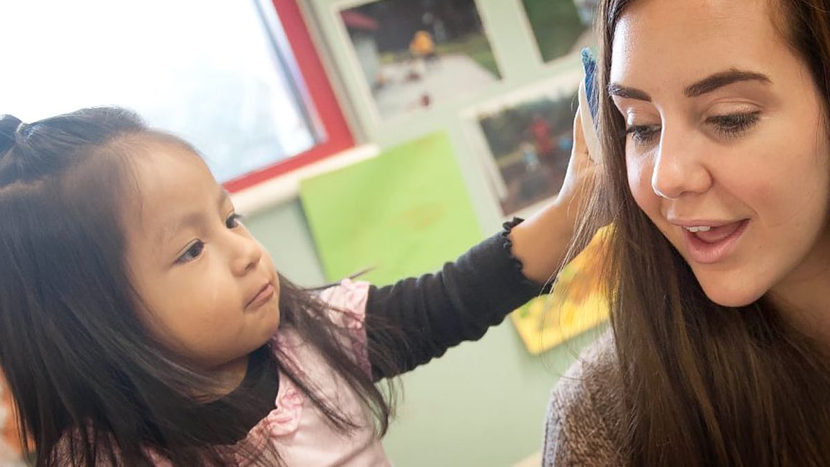 Girl playing with her teacher