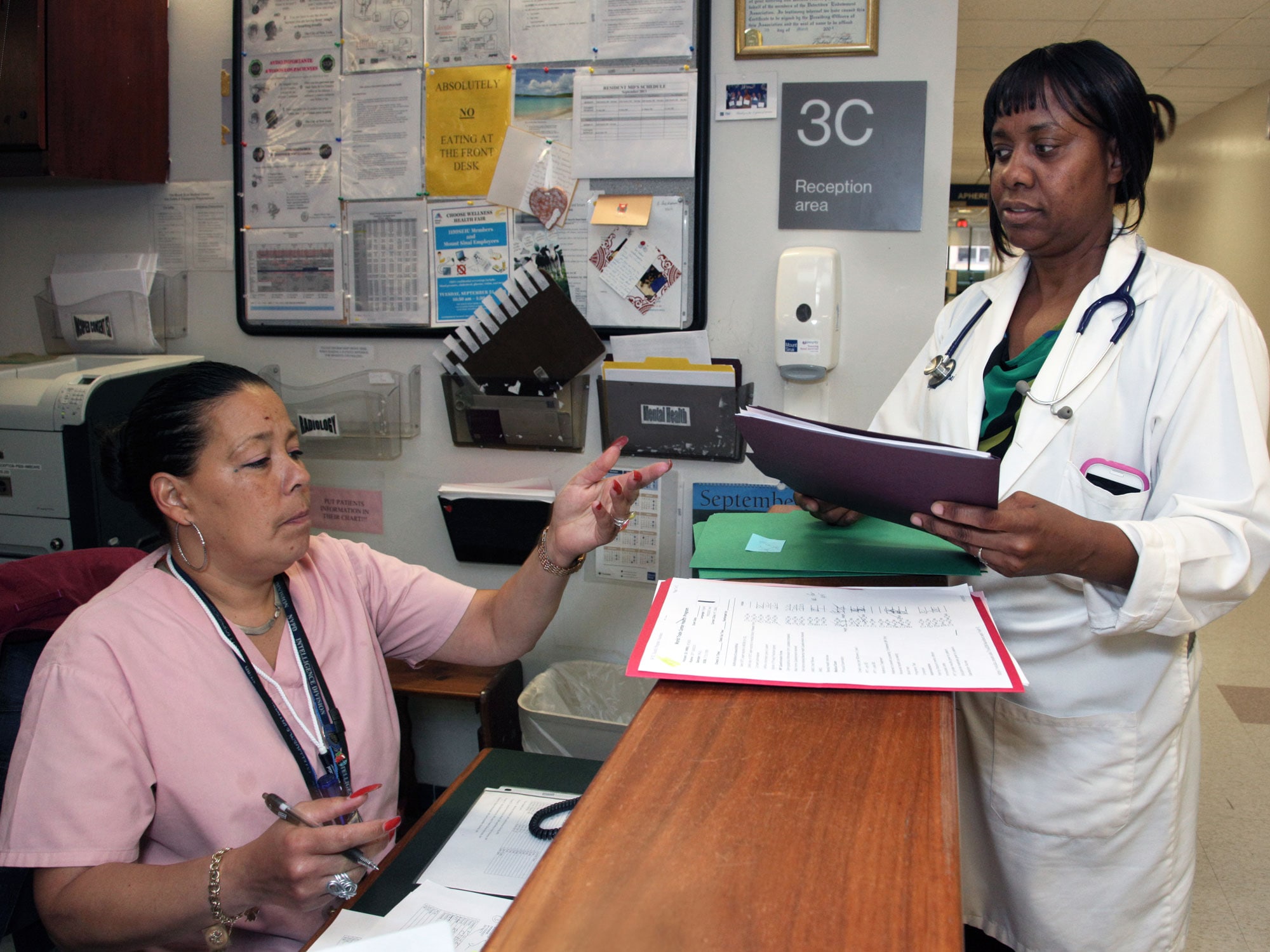 Mount Sinai staff members conferring at the program’s reception desk