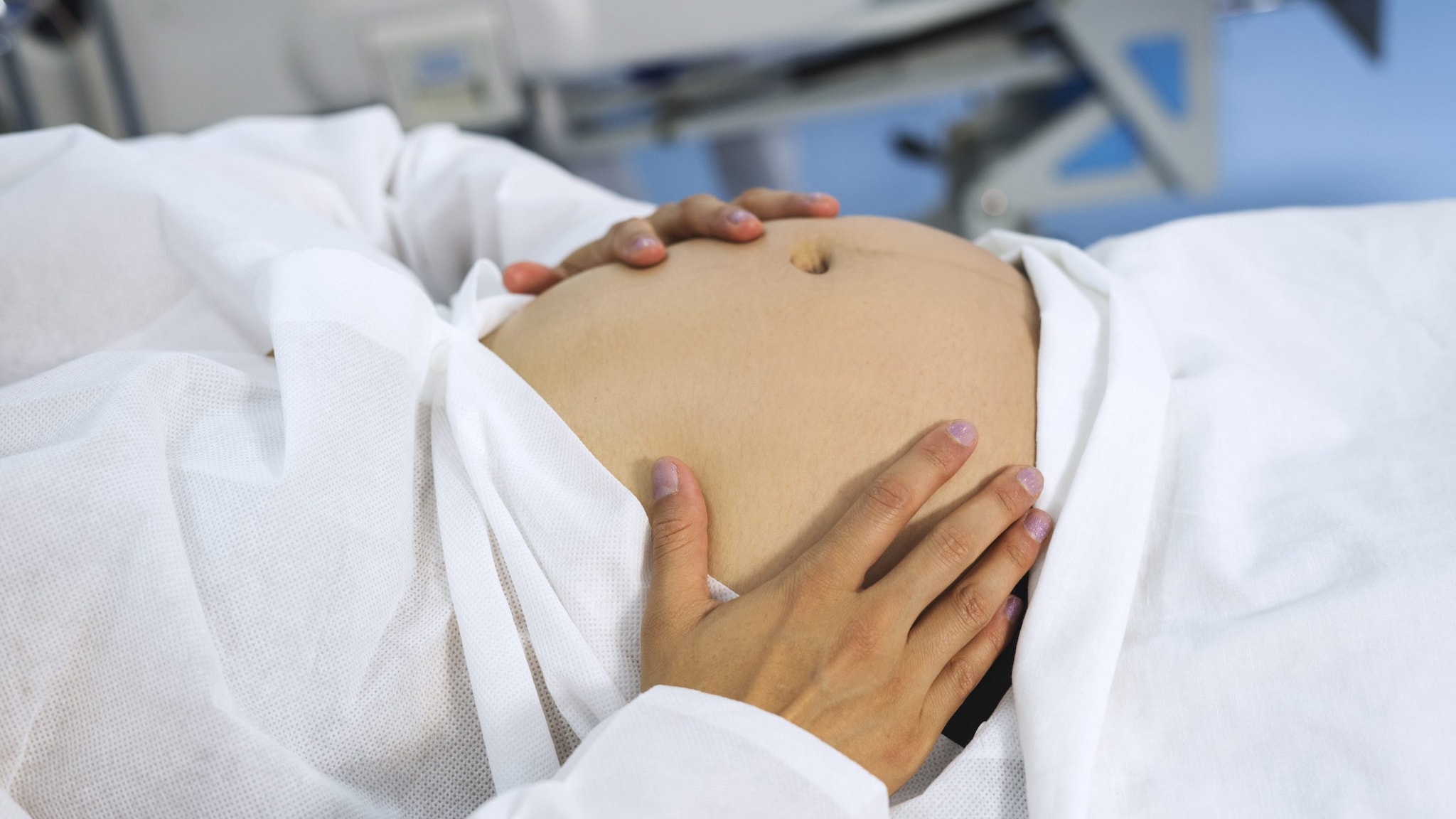 Pregnant woman holding her belly